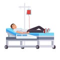 Young man is lying on the hospital bed donating blood