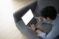 Casual man lying on sofa and surfing internet on laptop computer at home. Royalty Free Stock Photo