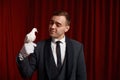 Young man magician showing trick with white dove bird selective focus Royalty Free Stock Photo