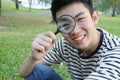 Young man with magnify glass Royalty Free Stock Photo