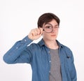 Young man with magnifying glass on grey background. Curious young man with magnifying glass Isolated on grey background Royalty Free Stock Photo