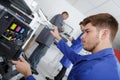 Young man maintaining photocopier Royalty Free Stock Photo
