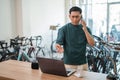 young man makes angry phone call while working on laptop Royalty Free Stock Photo