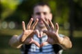 Young man makes hands in shape of love heart