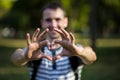 Young man makes hands in shape of love heart