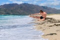 Young man makes a kick in a jump on the beach Royalty Free Stock Photo