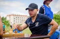 Young man makes a move playing chess in amateur competitions