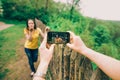 Young man makes photo of his girlfriend Royalty Free Stock Photo