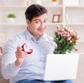 Young man making marriage proposal over internet laptop Royalty Free Stock Photo