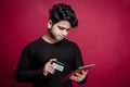 A young man making an online payment through debit credit card and tablet Royalty Free Stock Photo