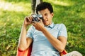 Young man making photographs on film camera