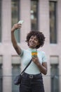 Young man making selfie with mobile phone. Young woman outdoors in the city. Technology and lifestyle concept Royalty Free Stock Photo