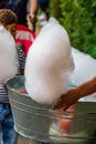 Young man making and selling cotton candy on an alley in the park at a festival in Bucharest, Romania, 2019 Royalty Free Stock Photo