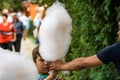 Young man making and selling cotton candy on an alley in the park at a festival in Bucharest, Romania, 2019 Royalty Free Stock Photo