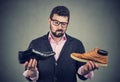 Young man making a shoe choice Royalty Free Stock Photo