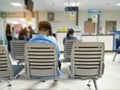 Young man and many people waiting medical and health services to the hospital Royalty Free Stock Photo