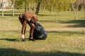 A young man in a mask is engaged in cleaning garbage in a park. pandemic environment concept Royalty Free Stock Photo