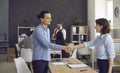 Young man and mature woman handshake in office after job recruitment meeting Royalty Free Stock Photo