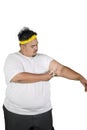 Young man measures fat layer of his arm on studio Royalty Free Stock Photo