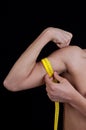 Young man measuring his arm Royalty Free Stock Photo