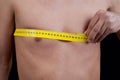 Young man measuring his chest Royalty Free Stock Photo