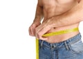 Young man measuring his waist. Royalty Free Stock Photo