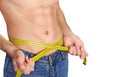 Young man measuring his waist. Royalty Free Stock Photo