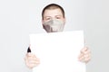 Young man in medical mask showing white blank empty signboard banner with copy space Royalty Free Stock Photo