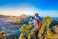 Young man meets the sunrise at the Bromo Tengger Semeru National Park on the Java Island, Indonesia. He enjoys Royalty Free Stock Photo