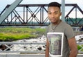 Young man on metal bridge structure, river and railway beams Royalty Free Stock Photo