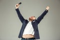 Young man with microphone on gray background, leading with microphone Royalty Free Stock Photo