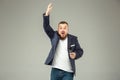 Young man with microphone on gray background, leading with microphone Royalty Free Stock Photo