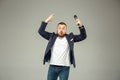 Young man with microphone on gray background, leading with microphone Royalty Free Stock Photo