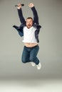 Young man with microphone on gray background, leading with microphone Royalty Free Stock Photo