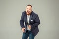 Young man with microphone on gray background, leading with microphone Royalty Free Stock Photo