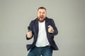 Young man with microphone on gray background, leading with microphone Royalty Free Stock Photo