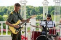 A young man in a military uniform with a guitar in his hands and a drummer at a concert. Open-air military concert in Moscow Royalty Free Stock Photo