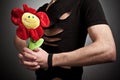 Young man in modern black clothing holding bouquet of narcissus Royalty Free Stock Photo