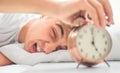 Young man is morning shocked grimace waking up alarm clock Royalty Free Stock Photo