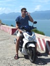 Young man a motorbike driver drinking water from a plastic bottle Royalty Free Stock Photo