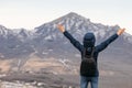 Young man in mountains at the top held up her hands Royalty Free Stock Photo