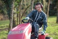 Young man mowing grass