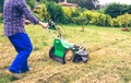 Young man mowing the lawn with lawnmower Royalty Free Stock Photo