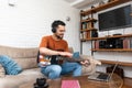 Young man music teacher giving guitar lessons to students online on laptop computer from home. Learning to play electric guitar Royalty Free Stock Photo