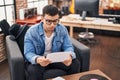 Young man musician reading music sheet at music studio Royalty Free Stock Photo