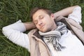 Young man napping alone on grass Royalty Free Stock Photo