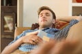 Young man napping on his couch Royalty Free Stock Photo