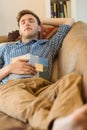 Young man napping on his couch Royalty Free Stock Photo