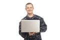 Young man in navy uniform using laptop