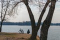 Young man near the bike, relaxing on the river bank Royalty Free Stock Photo